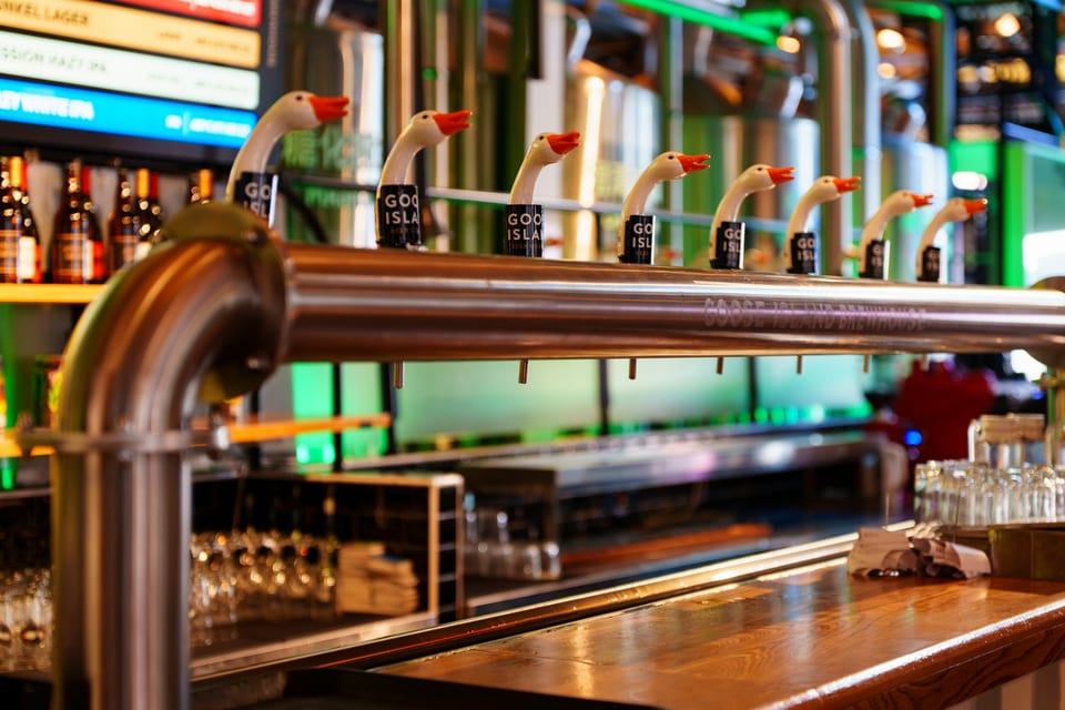 Beer taps across a polished bar counter